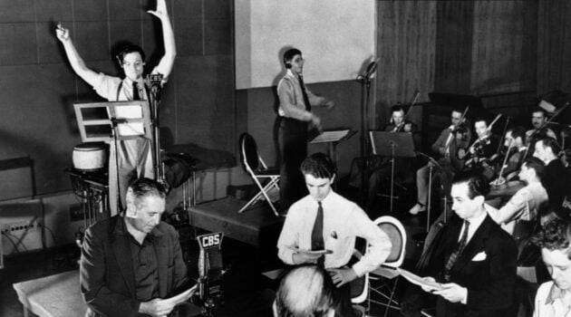 Orson Welles rehearsing The Mercury Theatre on the Air with his cast at a CBS Radio microphone in 1938
